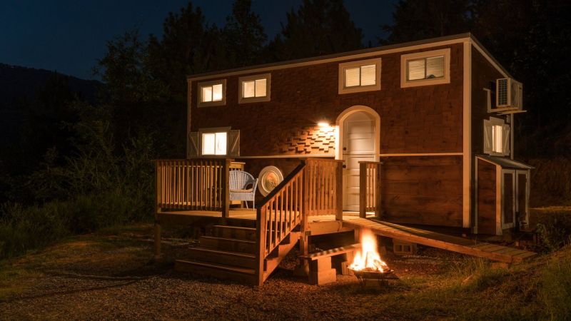 Old Blue Chair Tiny House has cozy reading nook under the staircase