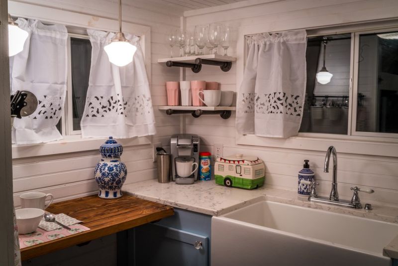 Old Blue Chair Tiny House has cozy reading nook under the staircase