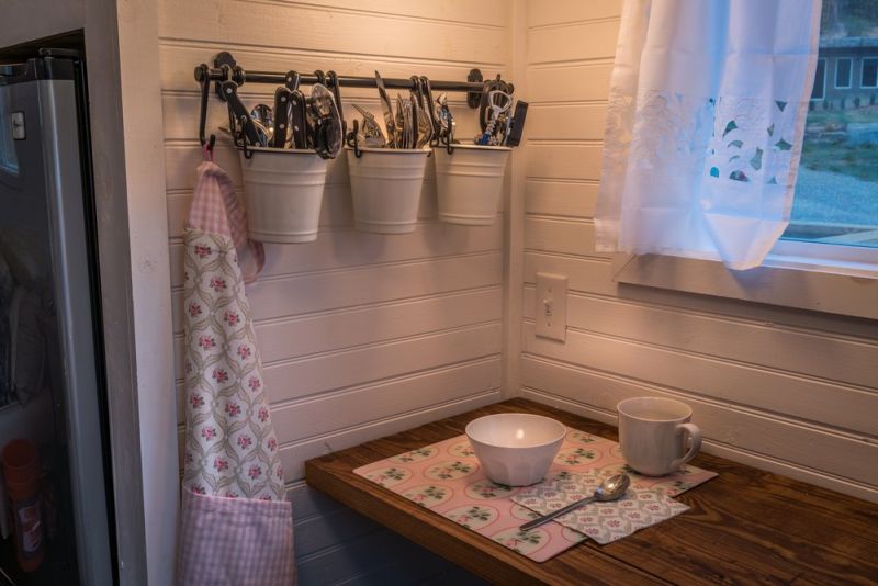 Old Blue Chair Tiny House has cozy reading nook under the staircase