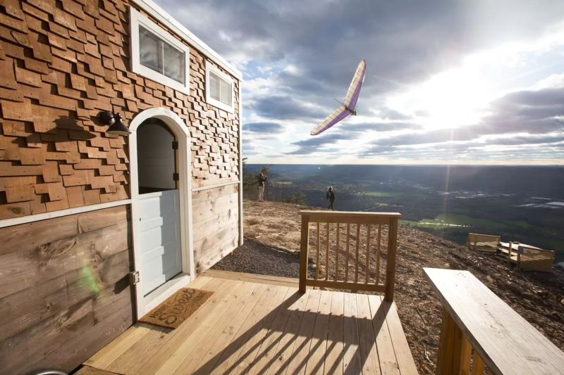 Old Blue Chair Tiny House has cozy reading nook under the staircase