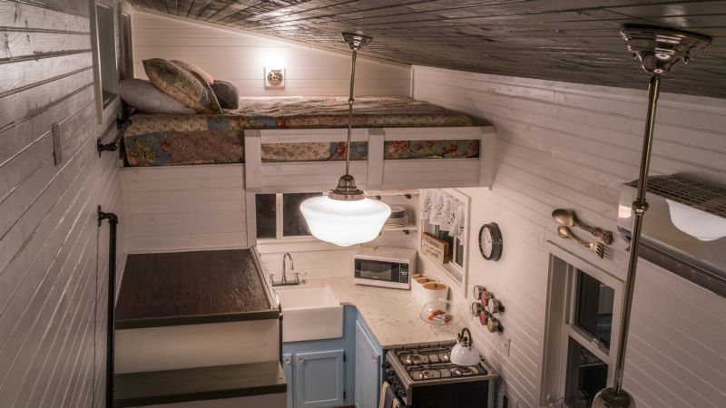 Old Blue Chair Tiny House has cozy reading nook under the staircase