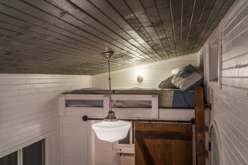 Old Blue Chair Tiny House has cozy reading nook under the staircase