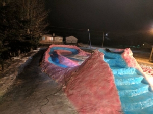 This snaking ice slide by Tracadie dad is colorful attraction for the entire neighborhood