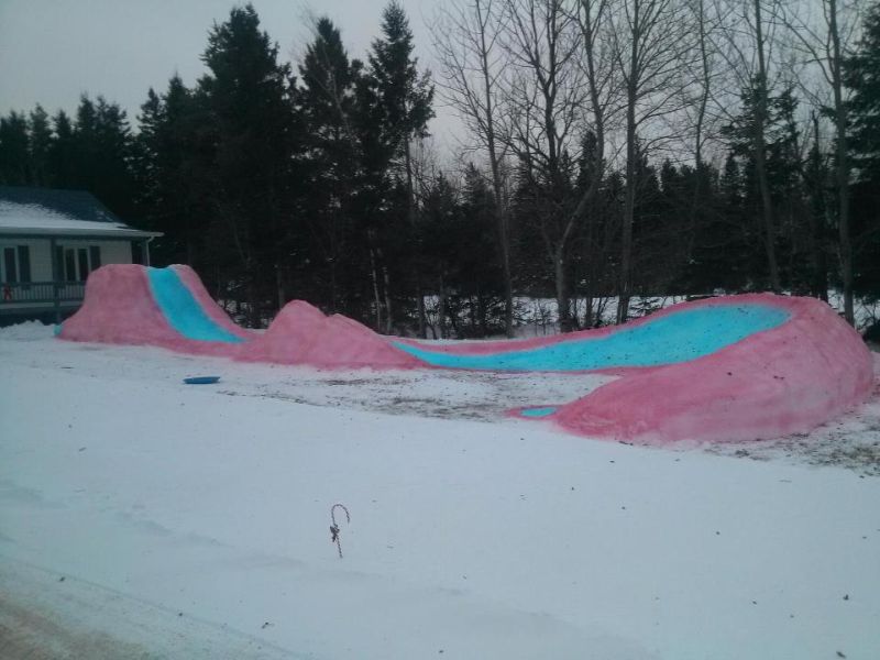 This snaking ice slide by Tracadie dad is colorful attraction for the entire neighborhood 