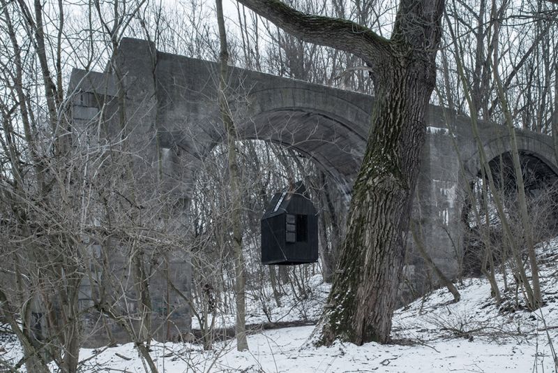 Take a tour of mysterious tiny house floating under an old railway bridge