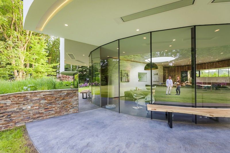 This circular house with big windows brings the outdoors in