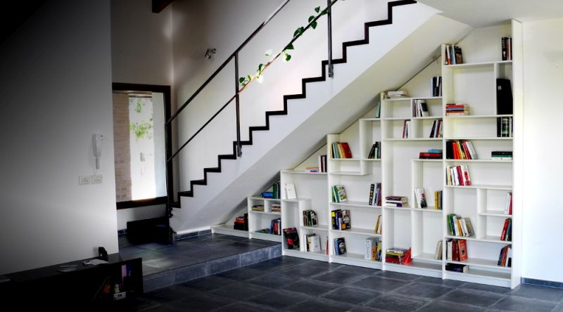 bookshelf under stairs