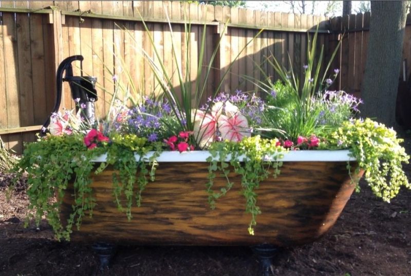 Old Bathtub planter painted stylishly from outside 