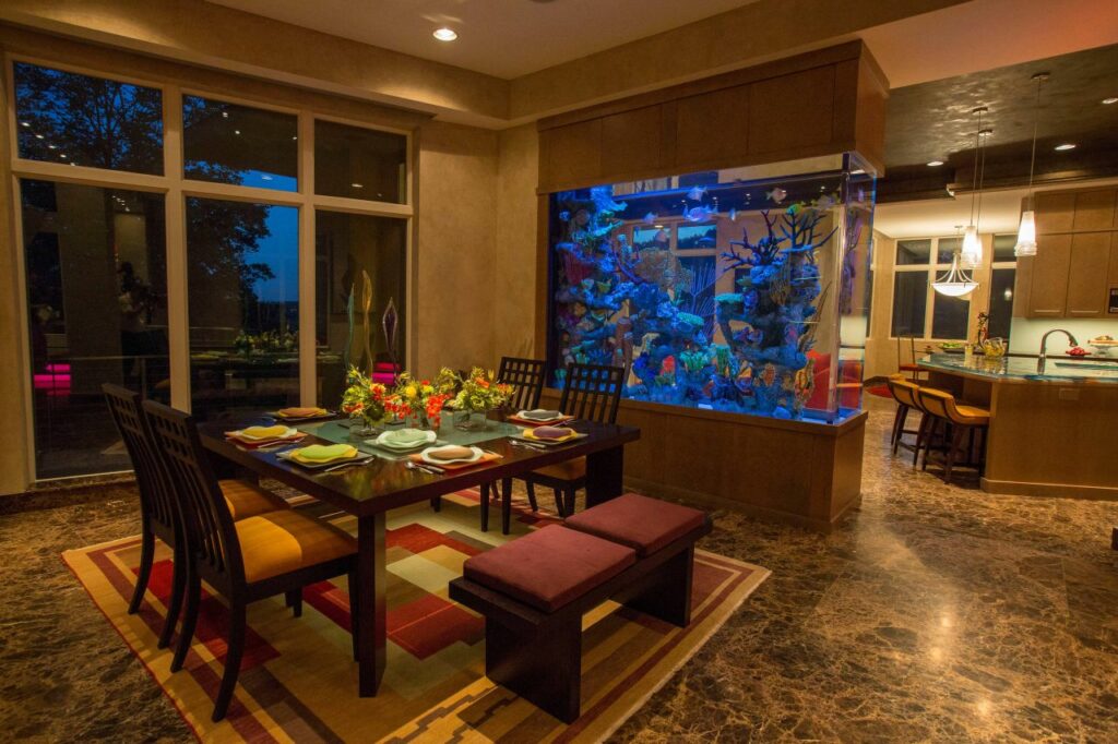 Dining room with double sided custom aquarium