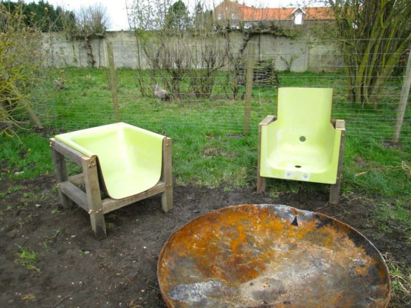 Old bathtub into chair with a wooden frame 