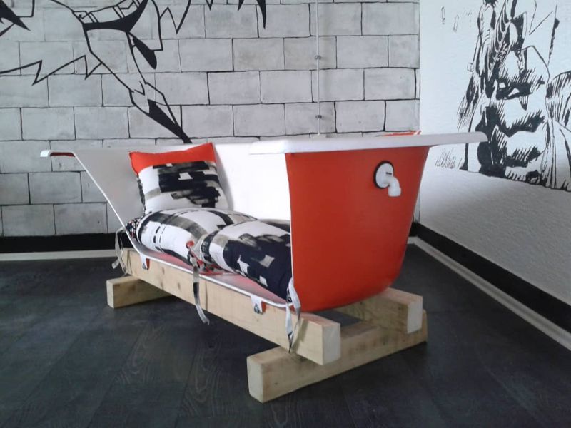 Old bathtub into a sofa with wooden base 