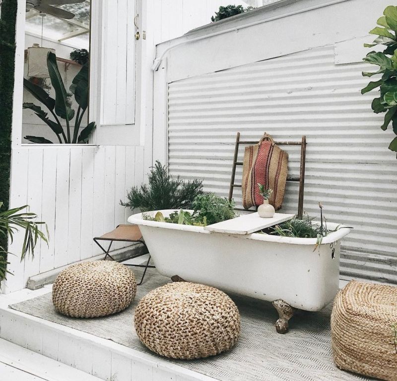 Old bathtub into planter in garden 