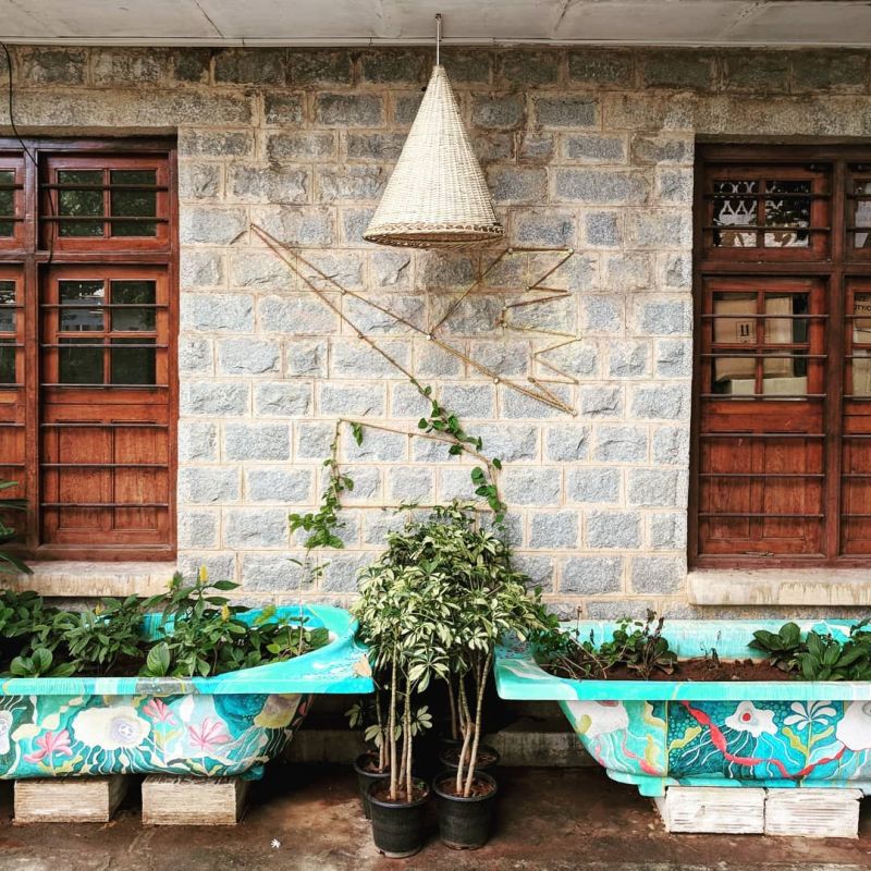 Old bathtub painted from outside serves as planter