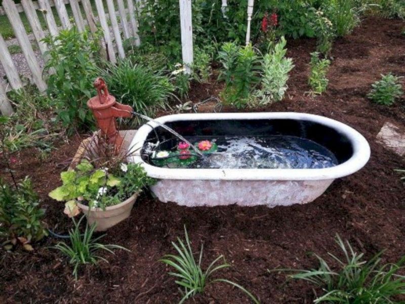 Old bathtub into water feature for garden 