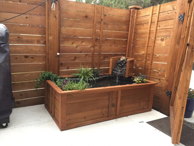 Old bathtub into a small garden pond