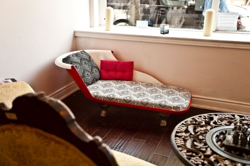 Old bathtub repurposed into a stylish red sofa