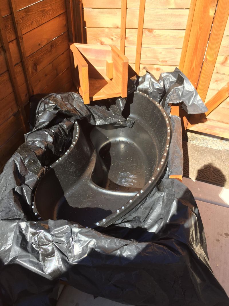 turn old bathtub into a natural-looking pond