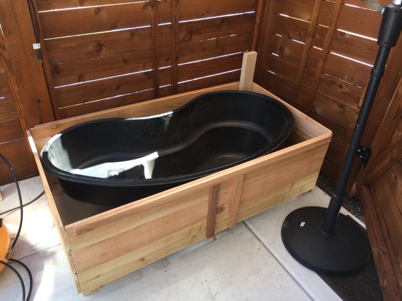 turn old bathtub into a natural-looking pond