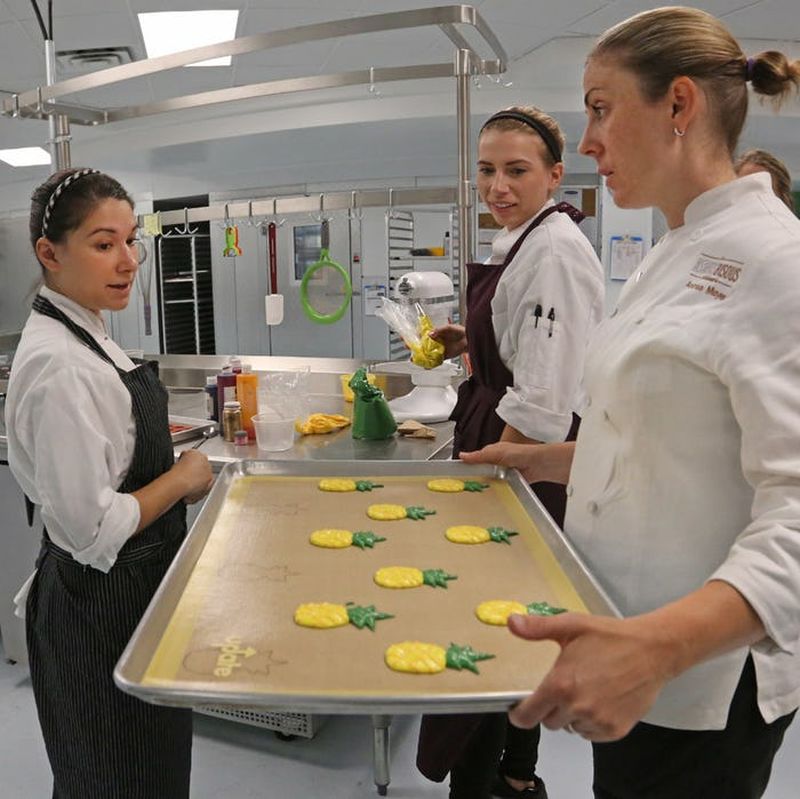 Chefs baking pineapple macarons in Bisous Bisous Patisserie's kitchen