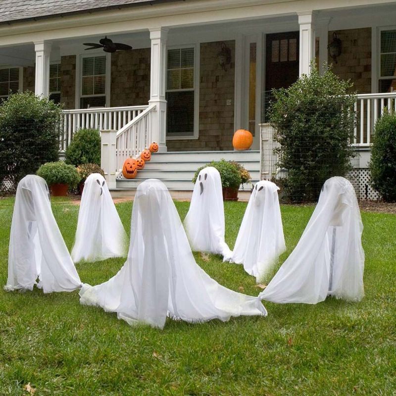 white bed sheet ghosts in garden  