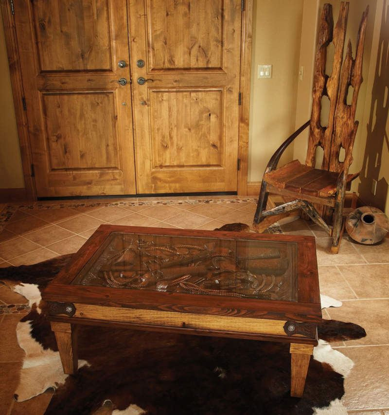 Hand carved Western coffee table with glass top 