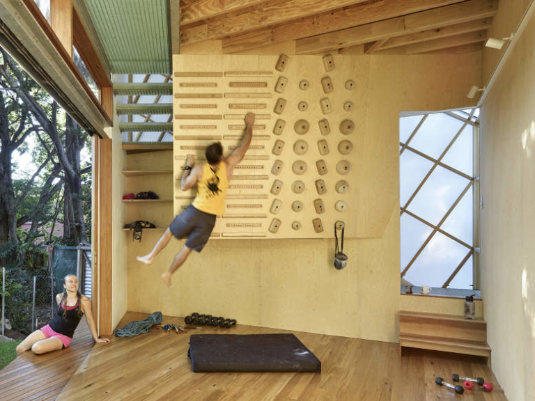 Treehouseinspired backyard extension with an indoor climbing wall