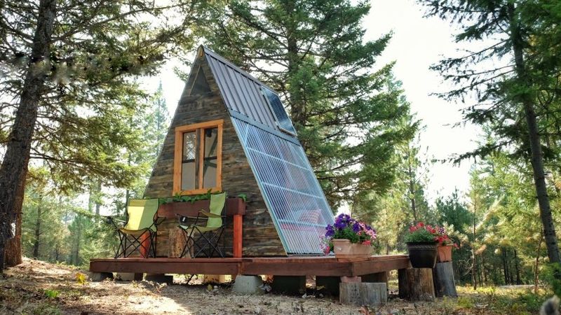 This solar-powered A-frame cabin features a retractable wall 