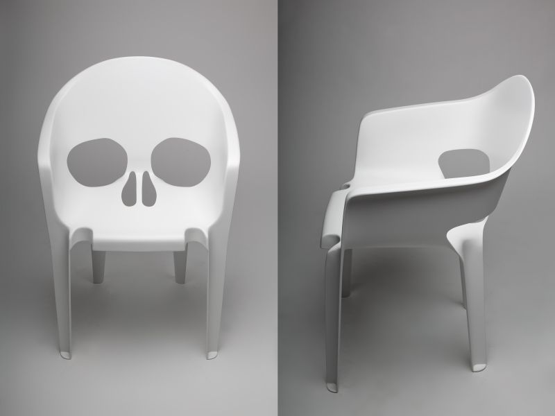 White fiberglass skull chair by pool