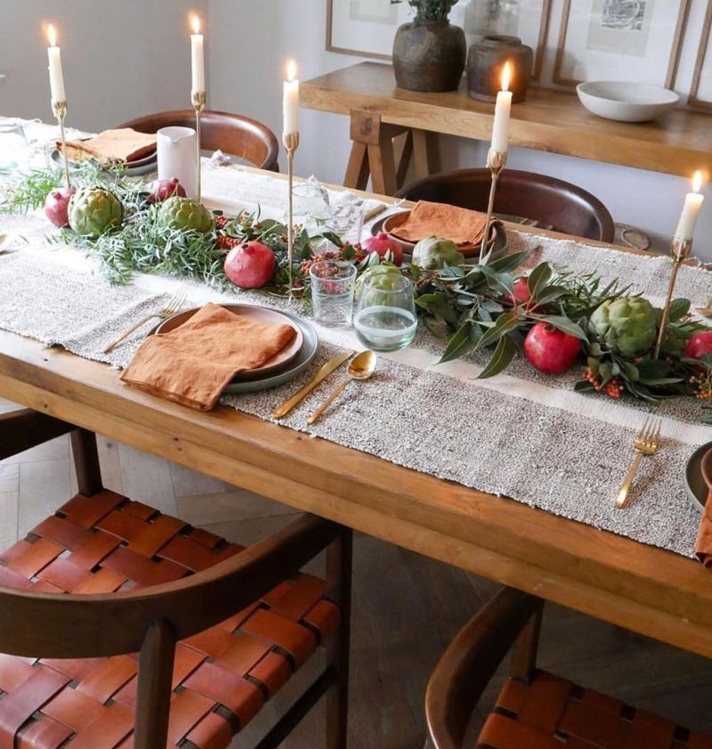 Thanksgiving Table with pomegranate and green leaves 