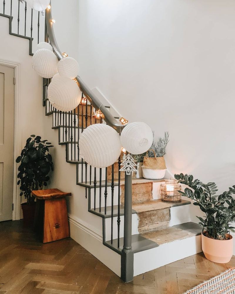 Paper lanterns and plants decorating staircase for Christmas 