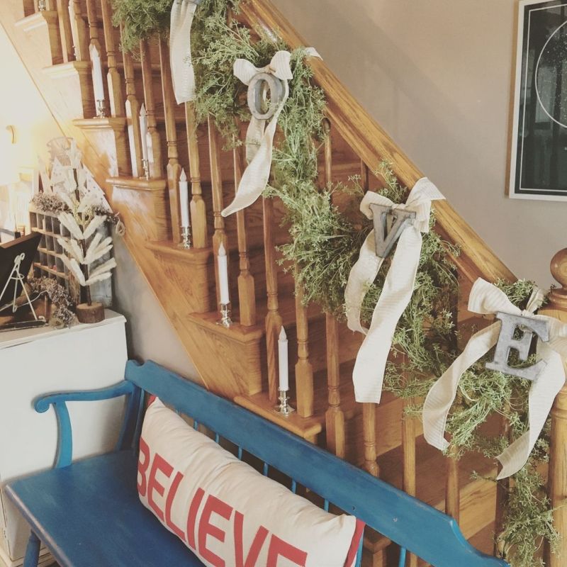 Candles, letters, ribbons and garland on staircase 