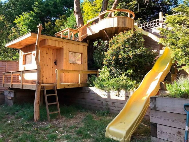 Dad Builds Garden Treehouse with Slides For His Daughters