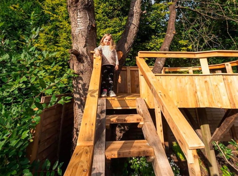 Dad Builds Garden Treehouse with Slides For His Daughters