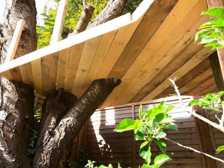 Dad Builds Garden Treehouse with Slides For His Daughters