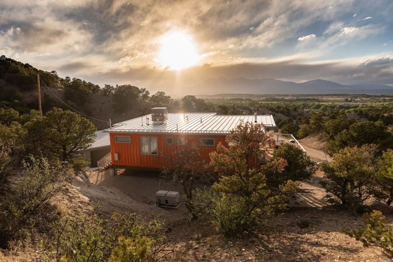 Nestled in the foothills of the Sangre de Cristo Mountains, this orange shipping container rental home is a cool getaway near Salida, Colorado