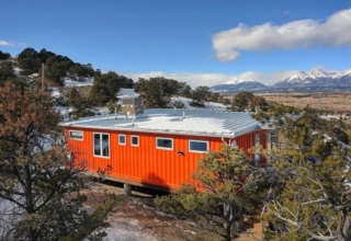 Nestled in the foothills of the Sangre de Cristo Mountains, this orange shipping container rental home is a cool getaway near Salida, Colorado