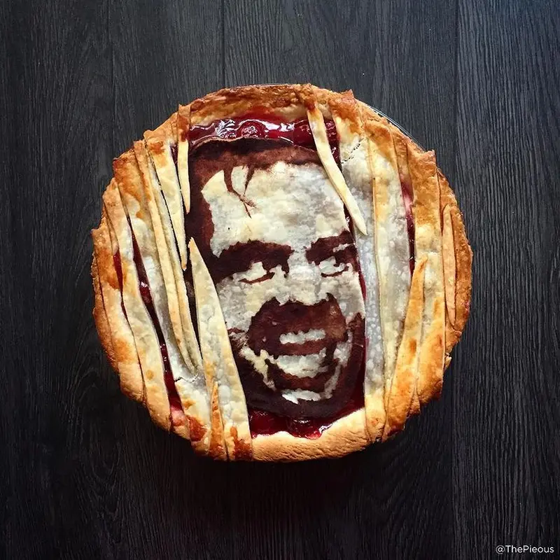 Jack Torrance trying to get through a splintered door to kill his son Danny on a pie