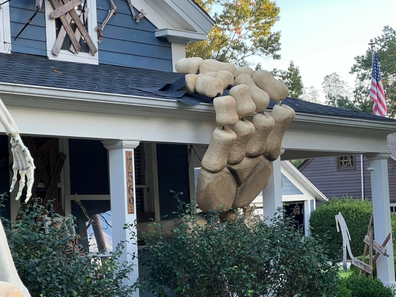 Artist Builds Gigantic Skull Arms Breaking Out of His Home for Halloween