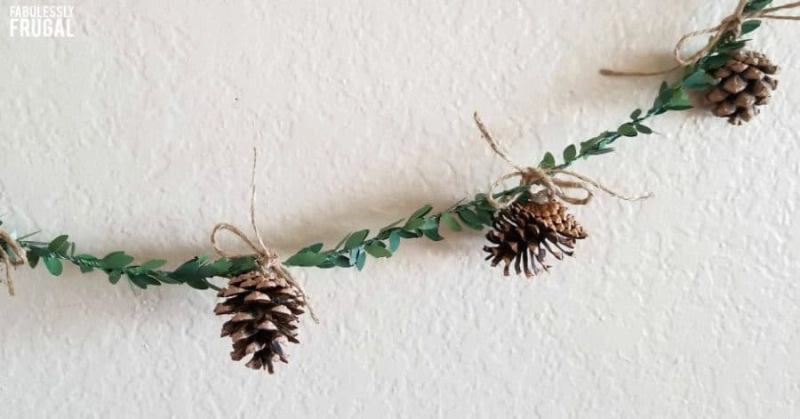 Combine pine cones with green garland and twine