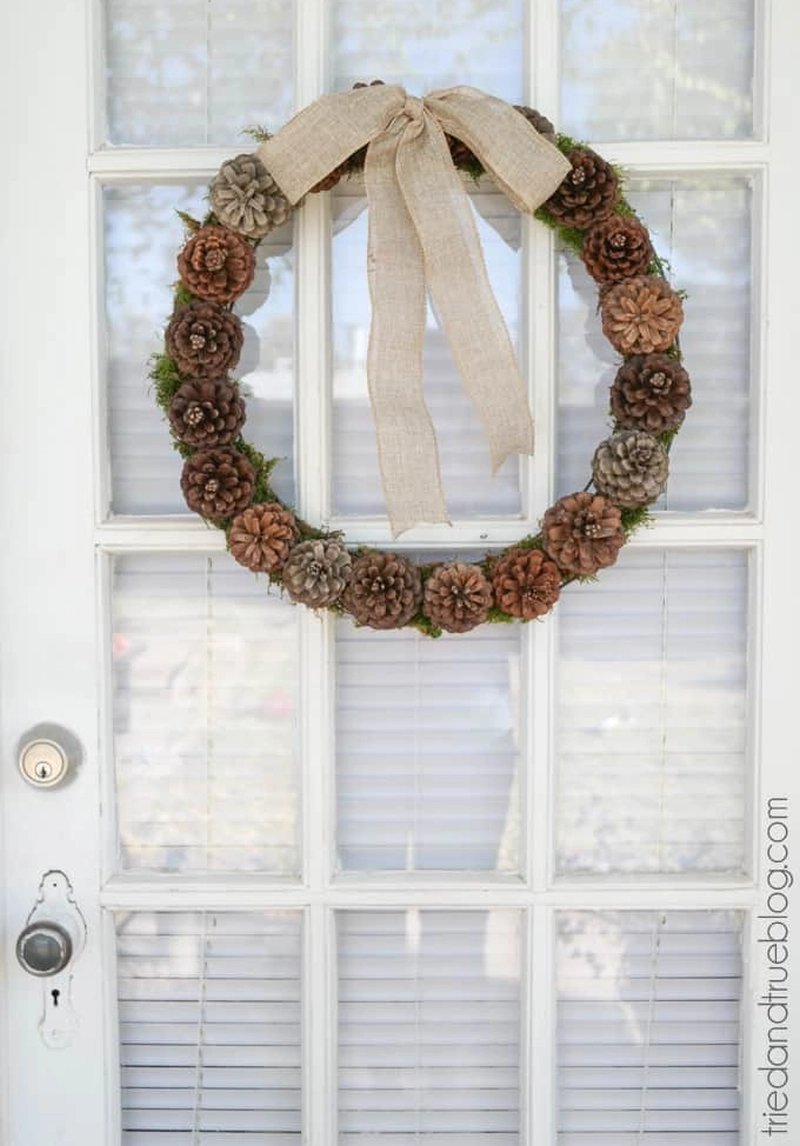 Christmas wreath with pine cones and large burlap bow 