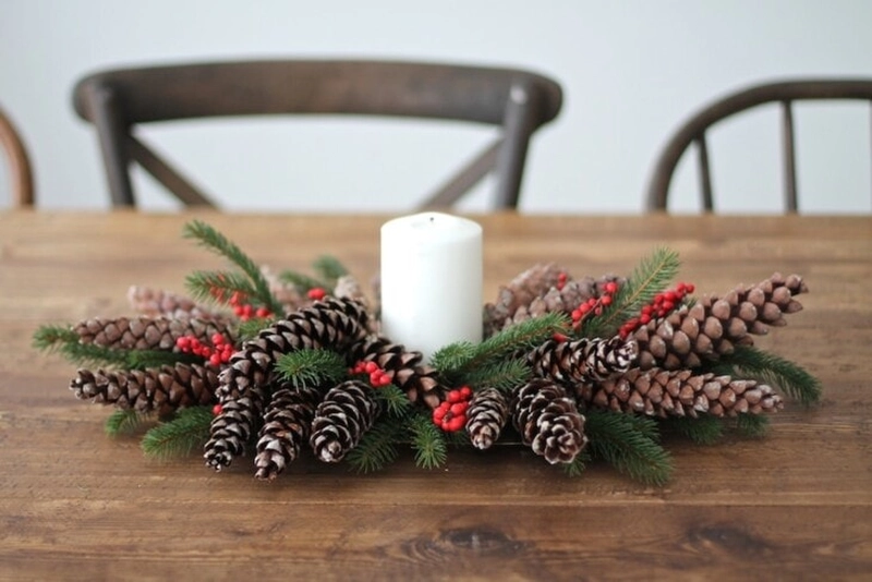 Arrange beautiful berries, candles and pine cones for table decor