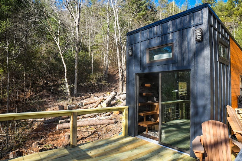 Industrial Tiny Cabin Sits Next To Icy Blue-Green Pond in North Carolina