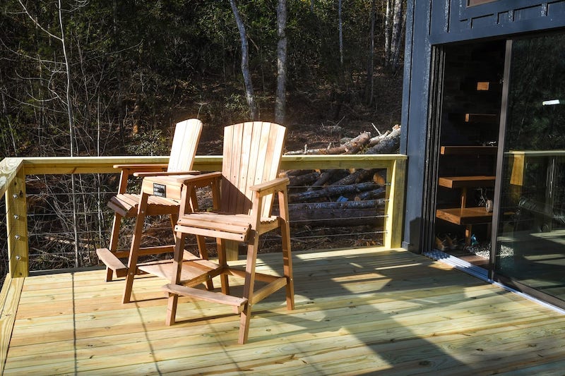 Industrial Tiny Cabin Sits Next To Icy Blue-Green Pond in North Carolina