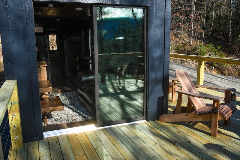 Industrial Tiny Cabin Sits Next To Icy Blue-Green Pond in North Carolina