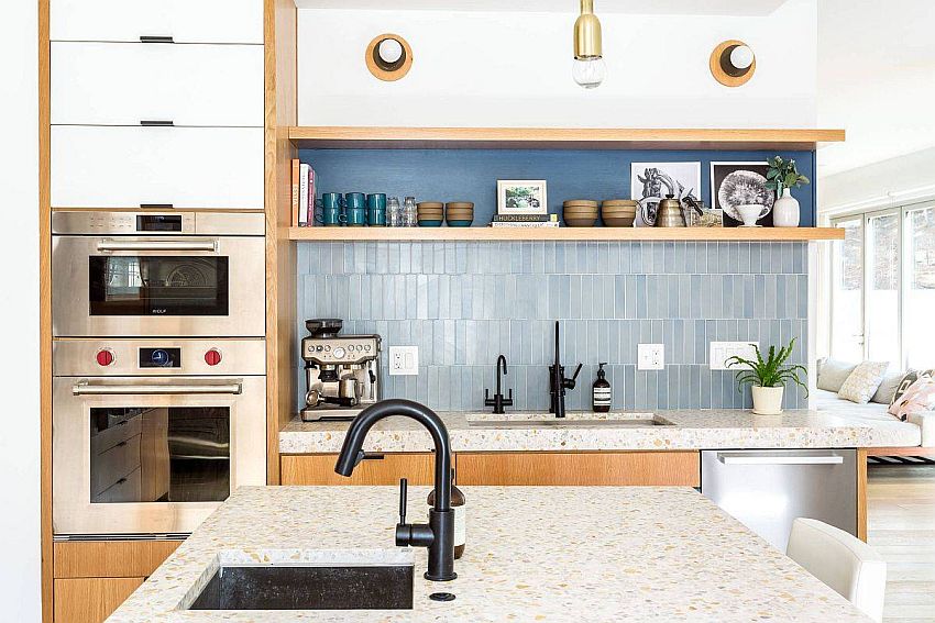 Vertical tiles, floating wooden shelves and neutral backdrop shape this functional kitchen