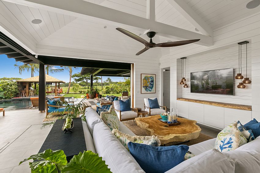 Live-edge wooden slab in the backdrop for the entertainment wall complements the coffee table