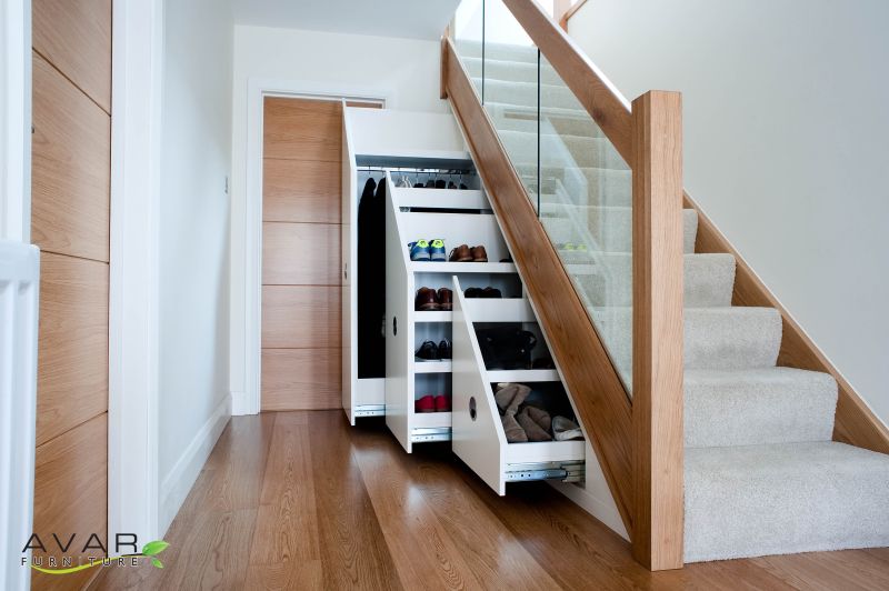 space under stairs as clothes closet and shoe rack