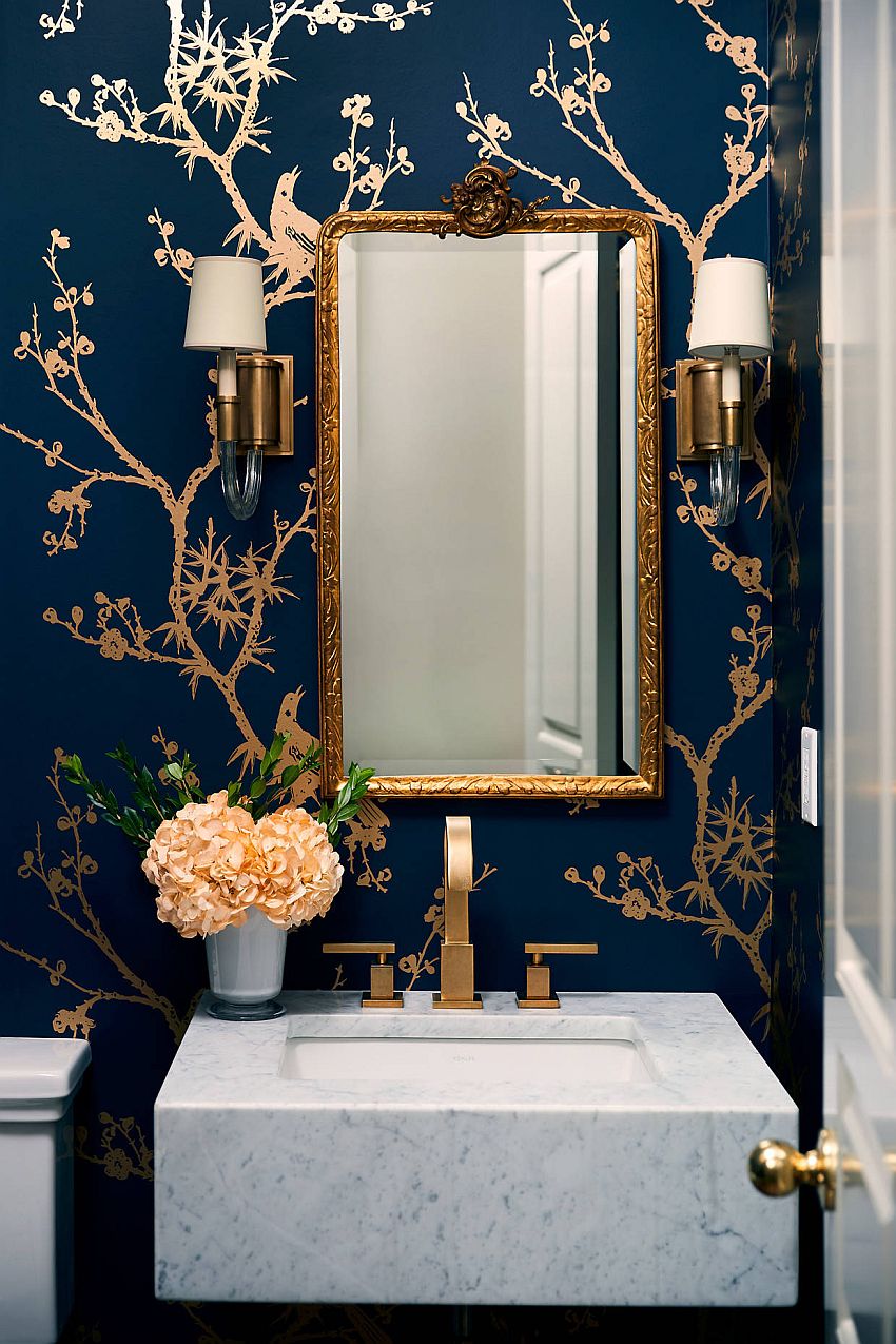 Gold-framed mirror along with wallpaper that also features eye-catching gold pattern