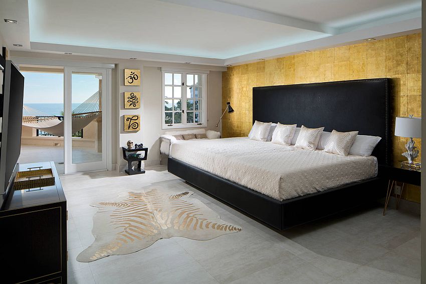 Master bedroom in white with gold accent wall