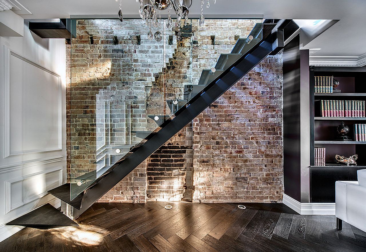 Modern living room with brick accent wall next to staircase